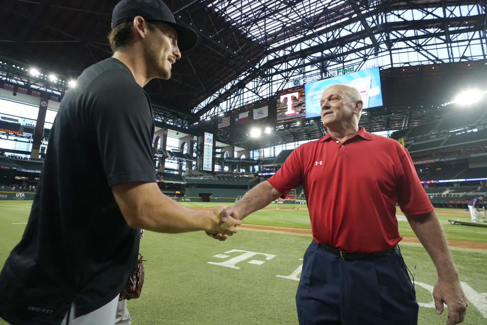 Former Texas Rangers pitcher David Clyde, right, meets Detroit Tigers pitcher Mason Englert before a baseball game between the Tigers and the Rangers in Arlington, Texas, Tuesday, June 27, 2023. The Tigers pitcher, a rookie from Forney, Texas, broke some of Clyde's Texas high school records. (AP Photo/LM Otero)