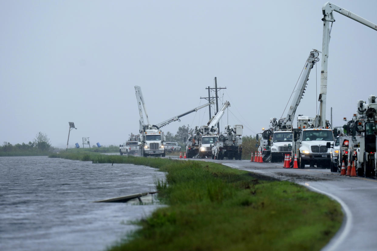 Utility crews replace power poles destroyed by Hurricane Ida as Tropical Storm Nicholas approaches in Pointe-aux-Chenes, La., Tuesday, Sept. 14, 2021. (AP Photo/Gerald Herbert)