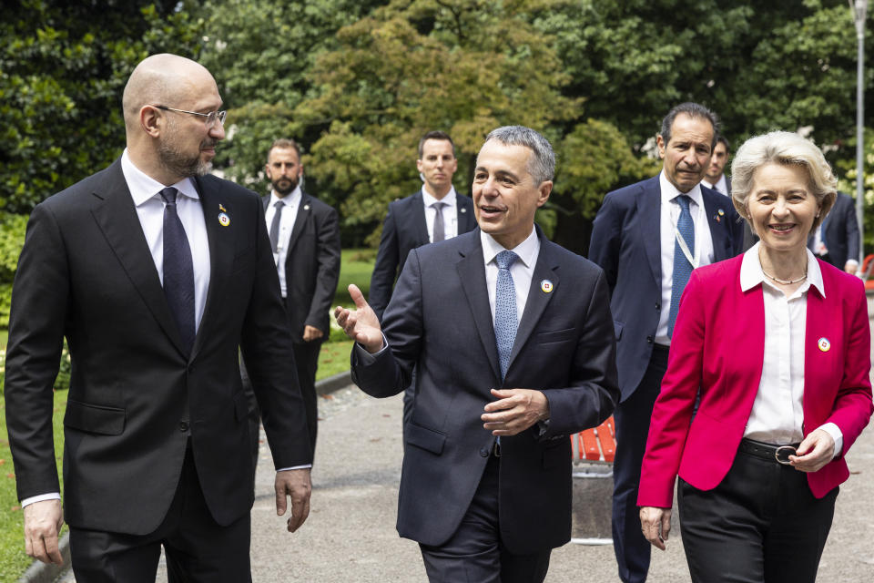 Ursula Von der Leyen, President of the European Commission, Swiss President Ignazio Cassis, Minister of Foreign Affairs, and Ukrainian Prime Minister Denys Shmyhal, from right, take a walk during the Ukraine Recovery Conference URC, Monday, July 4, 2022 in Lugano, Switzerland. The URC is organised to initiate the political process for the recovery of Ukraine after the attack of Russia to its territory. (Michael Buholzer/Keystone via AP)