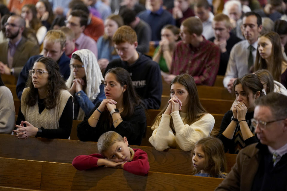 FILE - Catholics pray during Mass at Benedictine College Sunday, Dec. 3, 2023, in Atchison, Kan. Enrollment, now about 2,200, has doubled in 20 years. Some 85% of its students are Catholic, according to the Cardinal Newman Society. (AP Photo/Charlie Riedel, File)