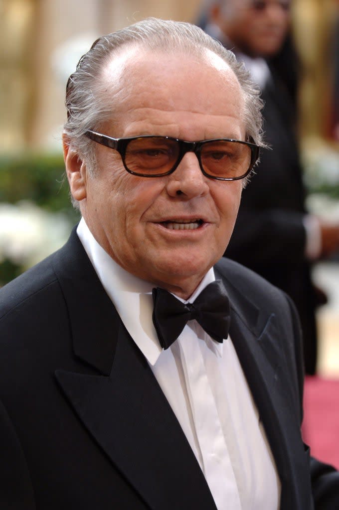 Jack Nicholson in a classic tuxedo with a bow tie and sunglasses