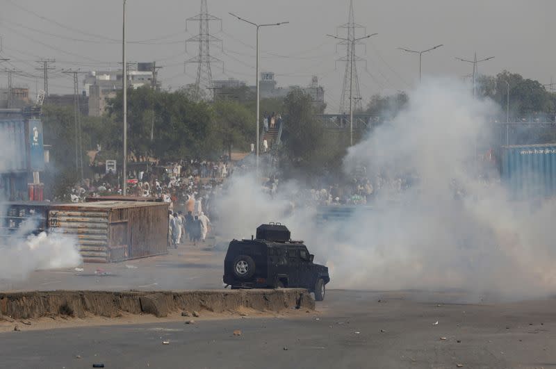 A police vehicle moves to disperse supporters of the Pakistan Tehreek-e-Insaf political party, in Rawalpindi