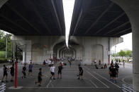 People gather to play basketball at a park Wednesday, June 3, 2020, in Yokohama, Japan. A coronavirus state of emergency was lifted, ending the restrictions nationwide as businesses began to reopen. (AP Photo/Kiichiro Sato)