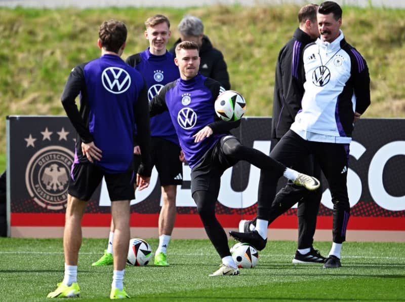 (L-R) Germany's Thomas Mueller, Maximilian Beier, Maximilian Mittelstaedt and assistant coach Sandro Wagner take part in a training session at DFB Campus ahead of the friendly match against France. Arne Dedert/dpa