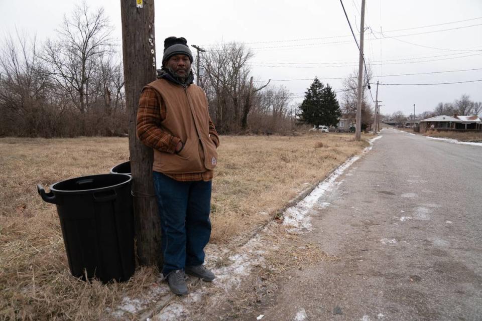 Shaun Murphy stands near trash cans on East St. Louis’s Bond St. after a cleanup on Jan. 15, 2024.