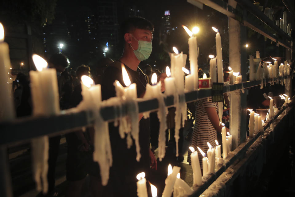 FILE - In this June 4, 2020, file photo, participants light candles during a vigil for the victims of the 1989 Tiananmen Square Massacre at Victoria Park in Causeway Bay, Hong Kong, despite applications for it being officially denied. Hong Kong authorities for the second year have banned the June 4 candlelight vigil to commemorate the bloody crackdown on pro-democracy protests in Beijing’s Tiananmen Square in 1989, organizers said Thursday, May 27, 2021. (AP Photo/Kin Cheung)