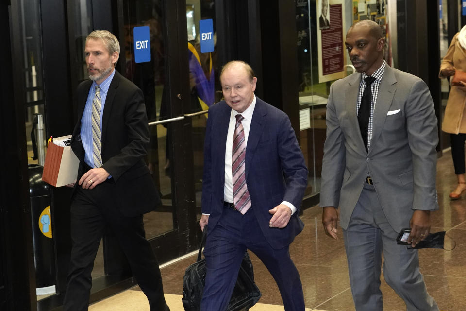 Special prosecutor Dan Webb, center, returns to the Leighton Criminal Courthouse, Thursday, Dec. 9, 2021, in Chicago, after the jury notified Cook County Judge James Linn that they have reached a verdict in actor Jussie Smollett's trial. (AP Photo/Charles Rex Arbogast)