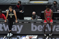 Milwaukee Bucks guard Sam Merrill, left, and Chicago Bulls forward Patrick Williams watch teammates during the first half of an NBA basketball game in Chicago, Sunday, May 16, 2021. (AP Photo/Nam Y. Huh)