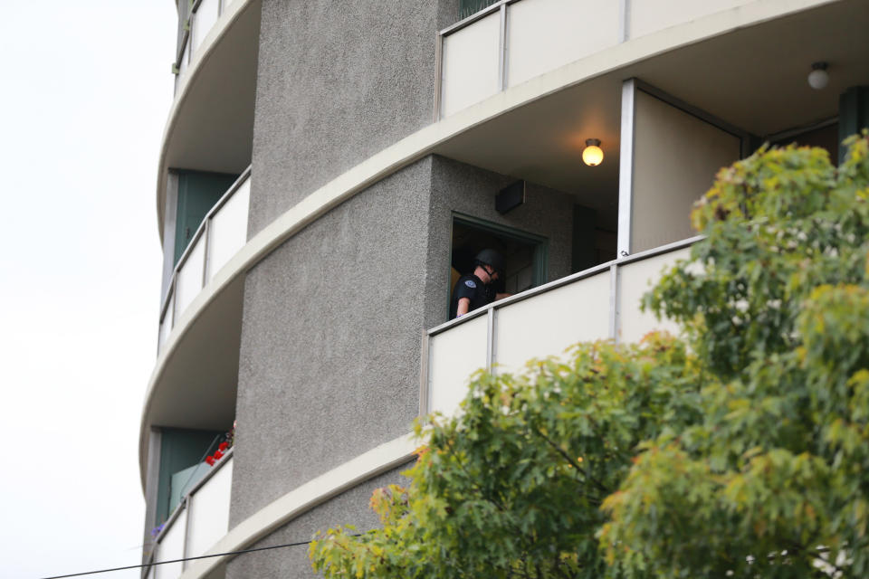 Police respond to a report of gunfire at Smith Tower Apartments in downtown Vancouver, Wash., on Thursday, Oct. 3, 2019. Authorities say a man opened fire Thursday in the lobby of the apartment building for seniors, striking several people. (Mark Graves/The Oregonian via AP)