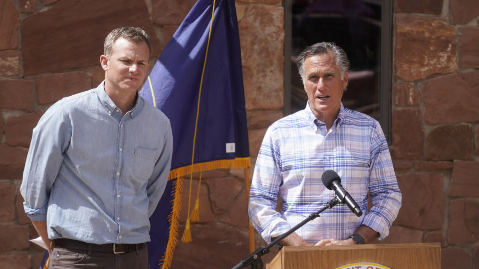 Rep. Blake Moore, left, looks on as Sen. Mitt Romney speaks during a news conference following a tour with U.S. Interior Secretary Deb Haaland to Bears Ears National Monument Thursday, April 8, 2021, near Blanding, Utah. (AP Photo/Rick Bowmer)