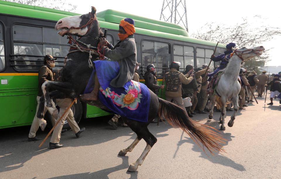 Men belonging to an armed Sikh order clash with police personnel as people take part in a ‘parallel parade’ on tractors and trolleys, during the ongoing farmers protest against new farm lawsEPA