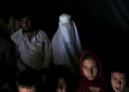 An Afghan family, returning from Pakistan, watch a short video clip about mines at a mines and explosives awareness program at a United Nations High Commissioner for Refugees (UNHCR) registration centre in Kabul, Afghanistan September 2, 2015. REUTERS/Ahmad Masood