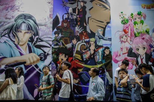 Visitors queue in front of billboards showing anime characters during the 14th Ani-Com and Games exhibition in Hong Kong. One of Asia's biggest animation and comic fairs opened Friday in Hong Kong, attracting thousands of fans and bringing some fun back into super heroes after the Batman movie shootings in Colorado