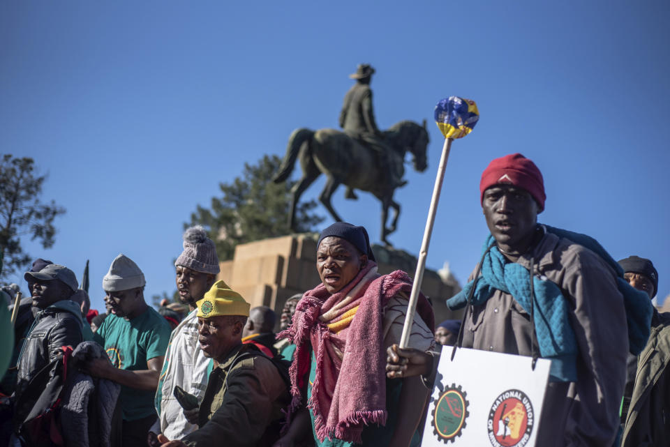 Striking miners protest for higher wages at the Union Buildings, in Pretoria, South Africa, Tuesday, May 24, 2022 as German Chancellor Olaf Scholz meets with South African President Cyril Ramaphosa on a one-day visit to the country. (AP Photo)