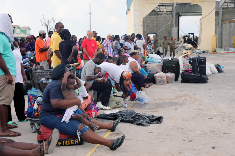 People wait in Marsh Harbour Port to be evacuated to Nassau, in Abaco, Bahamas, Friday, Sept. 6, 2019. The evacuation is slow and there is frustration for some who said they had nowhere to go after the Hurricane Dorian splintered whole neighborhoods. (AP Photo/Gonzalo Gaudenzi)