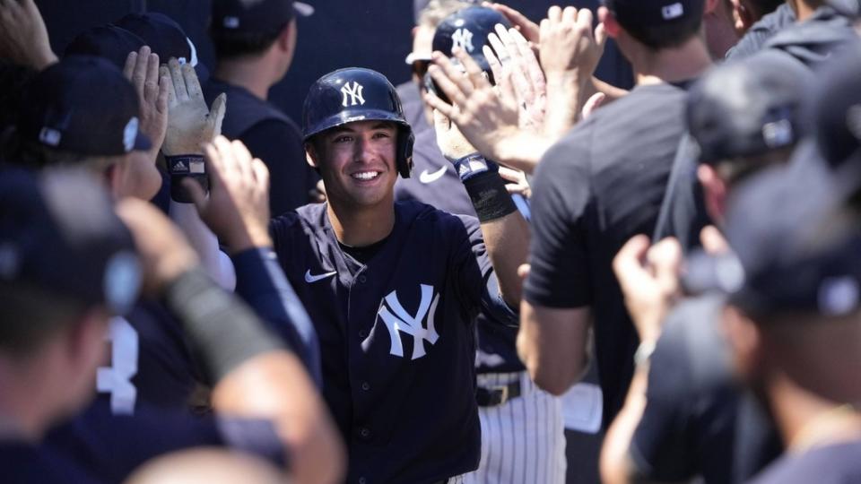 Mar 24, 2023;  Tampa, Florida, USA;  New York Yankees shortstop Anthony Volpe (77) is congratulated in the Yankees dugout after hitting a two run home run in the third inning against the Minnesota Twins at George M. Steinbrenner Field.