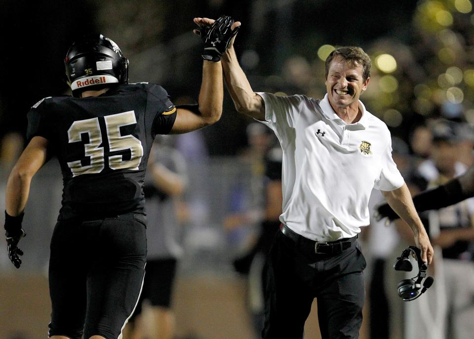 Buchholz Bobcats head coach Mark Whittemore celebrates with Kyle Brasfield after a blocked punt for a safety against the Vanguard Knights on Friday, Sept. 25, 2015 in Gainesville, Fla. Buchholz defeated Vanguard 33-32. Matt Stamey/Staff photographer
