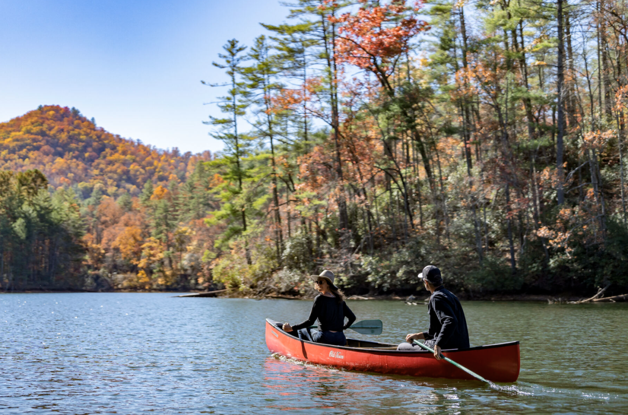 a couple in a canoe in the mountains of north carolina