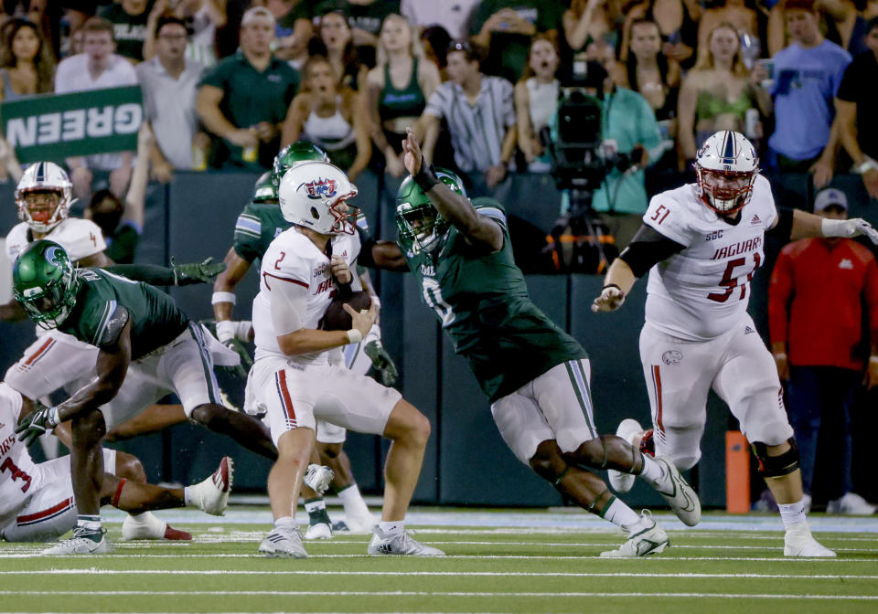 Tulane defensive lineman Patrick Jenkins (0) closes in for a sack of South Alabama quarterback Carter Bradley (2) during the second quarter of an NCAA college football game in New Orleans, Saturday, Sept. 2, 2023. (AP Photo/Derick Hingle)