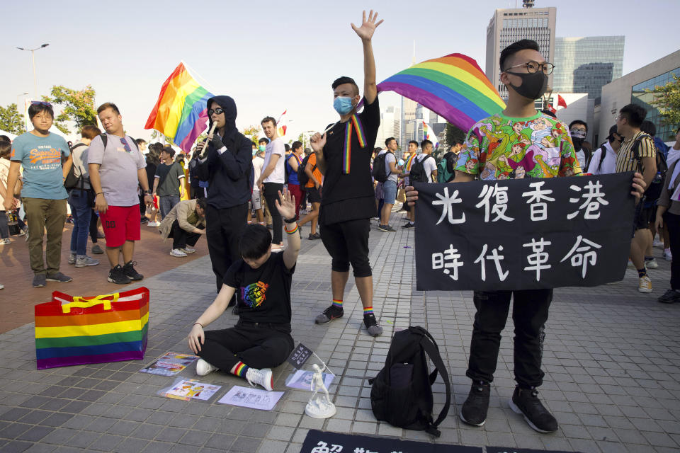 Demonstrators hold up their hands to represent the five demands of pro-democracy protestors during a gay pride rally in Hong Kong, Saturday, Nov. 16, 2019. Rebellious students and anti-government protesters abandoned their occupation of nearly all of Hong Kong's universities Saturday after a near weeklong siege by police, but at least one major campus remained under control of demonstrators. (AP Photo/Ng Han Guan)