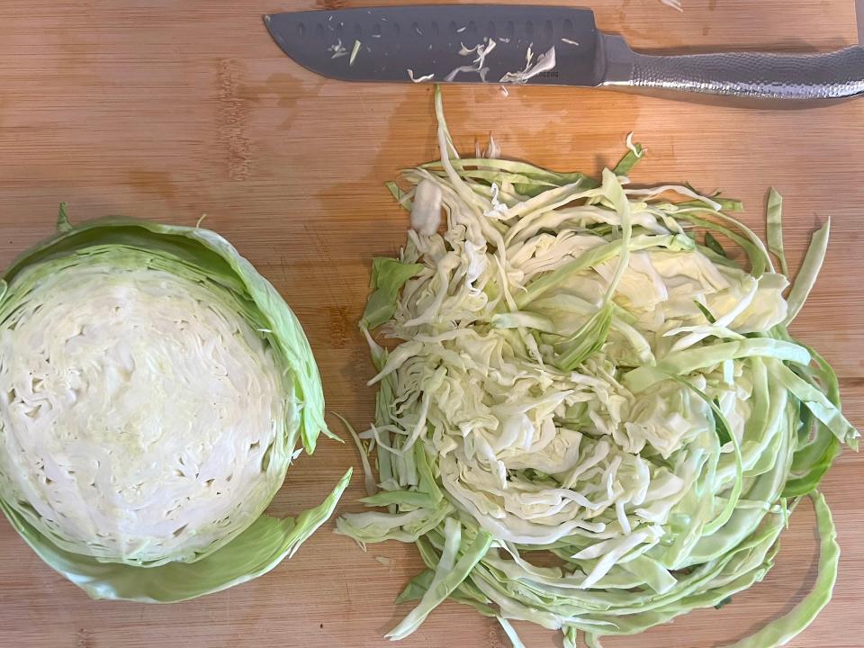 Shredding the cabbage with a knife.