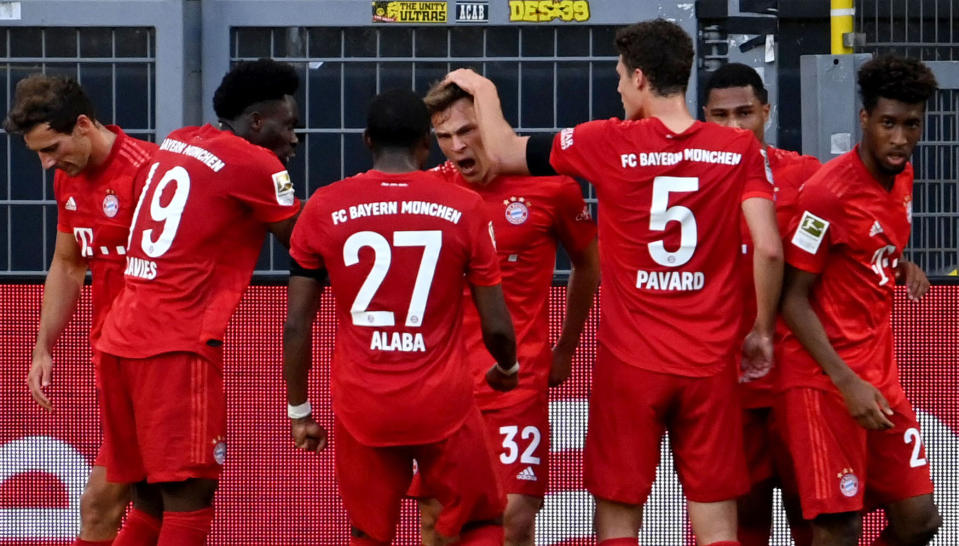 Bayern Munich's German midfielder Joshua Kimmich (C) celebrates scoring with his team-mates during the German first division Bundesliga football match BVB Borussia Dortmund v FC Bayern Munich on May 26, 2020 in Dortmund, western Germany. (Photo by Federico GAMBARINI / POOL / AFP) / DFL REGULATIONS PROHIBIT ANY USE OF PHOTOGRAPHS AS IMAGE SEQUENCES AND/OR QUASI-VIDEO (Photo by FEDERICO GAMBARINI/POOL/AFP via Getty Images)