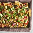 <p>These chicken nachos have crunchy chips topped with hot spiced shredded chicken, beans and melted cheese with cooling chunks of avocado, red onion and cilantro. If you like the heat, add jalapeño slices at the end. These quick nachos work well with shredded chicken breast or rotisserie chicken if you have leftovers around. <a href="https://www.eatingwell.com/recipe/7878127/chicken-nachos/" rel="nofollow noopener" target="_blank" data-ylk="slk:View Recipe" class="link rapid-noclick-resp">View Recipe</a></p>