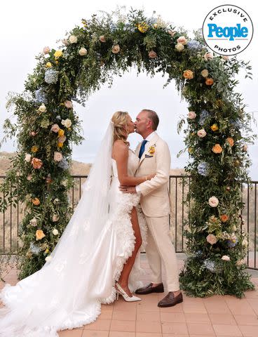 <p>Linda Puccio</p> Kary Brittingham and Mark A. Anderson share a kiss on their wedding day