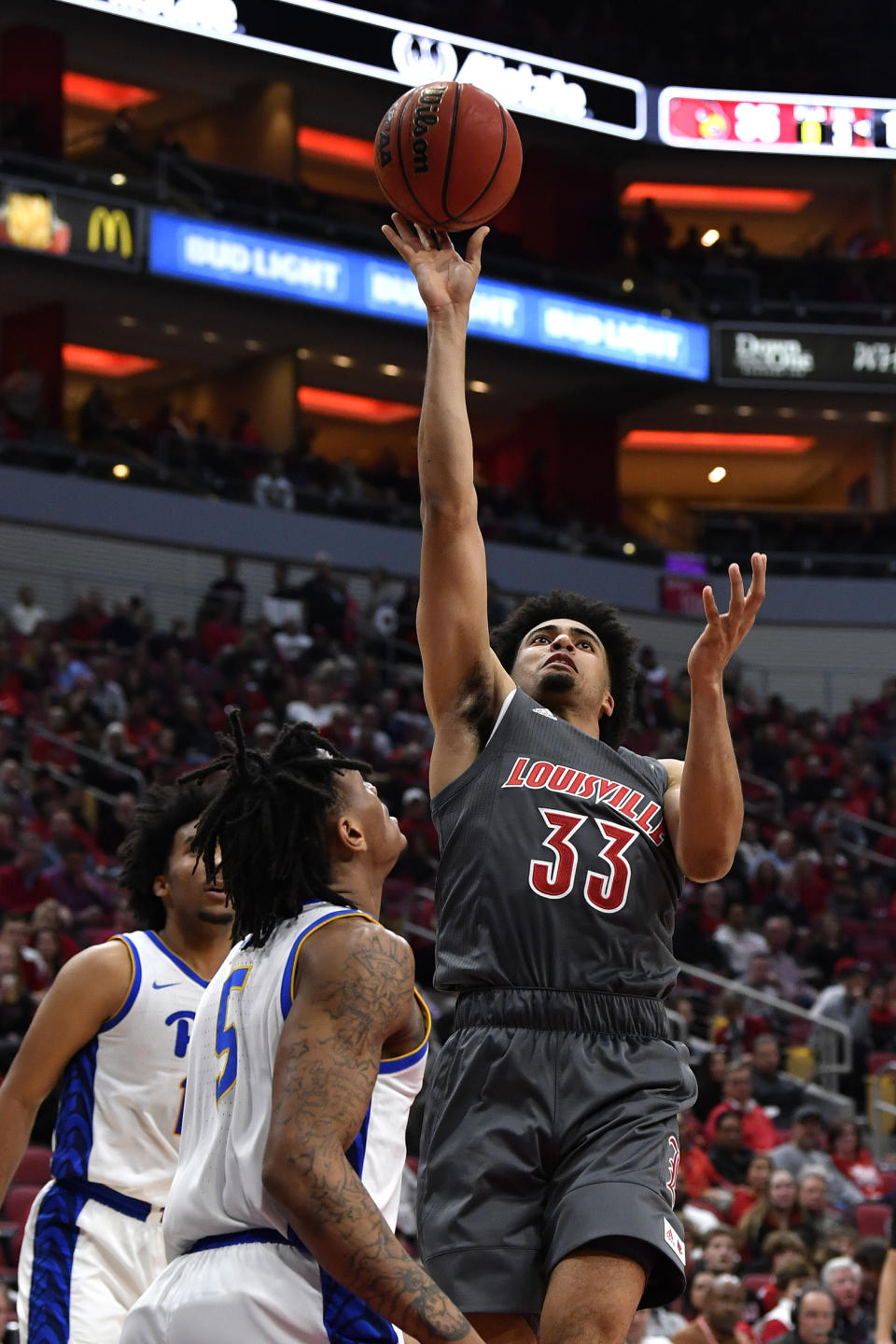 Louisville forward Jordan Nwora (33) goes in for a layup past the defense of Pittsburgh guard Au'Diese Toney (5) during the second half of an NCAA college basketball game in Louisville, Ky., Friday, Dec. 6, 2019. (AP Photo/Timothy D. Easley)