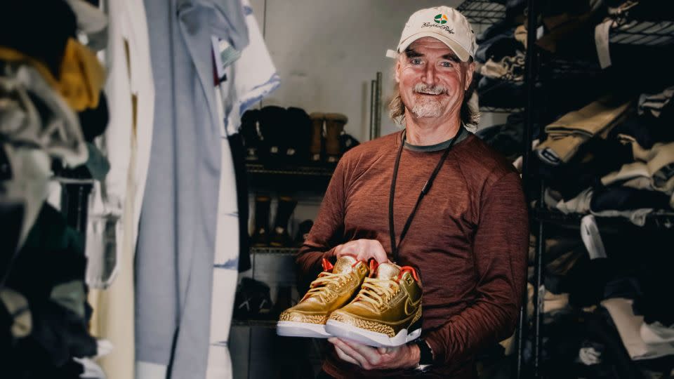 James Free is pictured holding a pair of of gold Nike Air Jordan 3 sneakers at the Portland Rescue Mission. - Aaron Ankrom/Portland Rescue Mission/AP