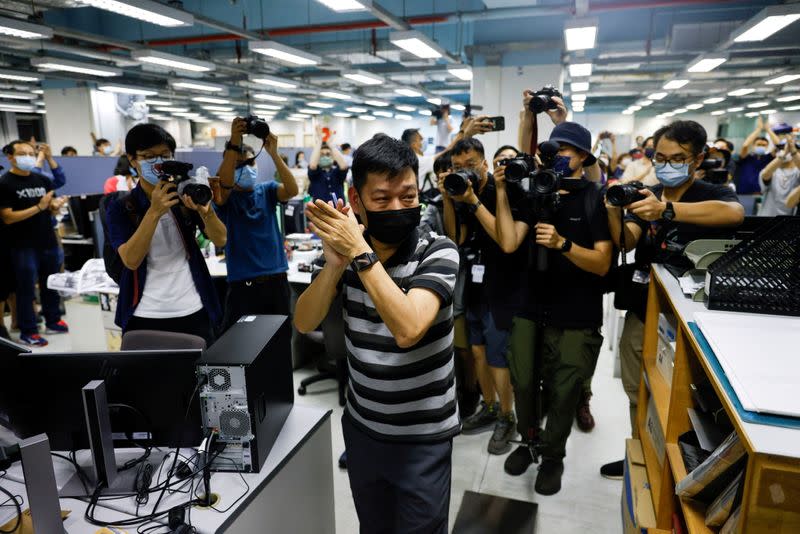 FILE PHOTO: Staff members of Apple Daily work on their final edition in Hong Kong