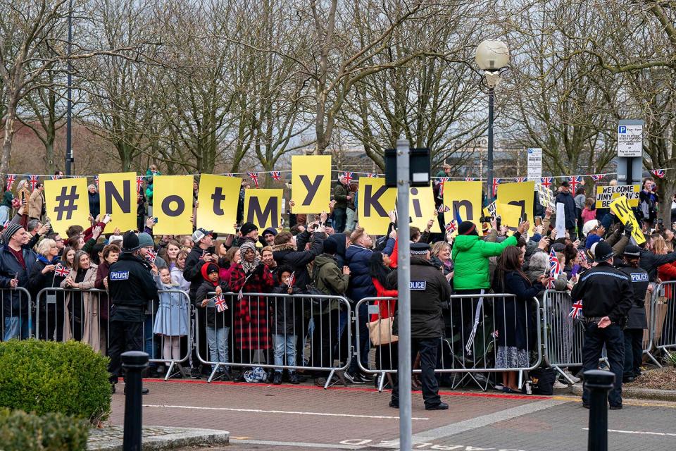 Demonstrators hold placards reading "Not My King" as Britain's King Charles III (unseen) arrives at the Church of Christ the Cornerstone in Milton Keynes, north of London on February 16, 2023, to attend a reception to mark Milton Keynes' new status as a city.