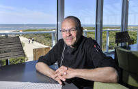 In this photo taken on Wednesday, May 15, 2019, restaurateur Michael Recktenwald talks to The Associated Press about his legal action against the EU to protect climate in his restaurant on the car-free environmental island of Langeoog in the North Sea, Germany. Concerns about climate change have prompted mass protests across Europe for the past year and are expected to draw tens of thousands onto the streets again Friday, May 24. For the first time, the issue is predicted to have a significant impact on this week’s elections for the European Parliament. (AP Photo/Martin Meissner)