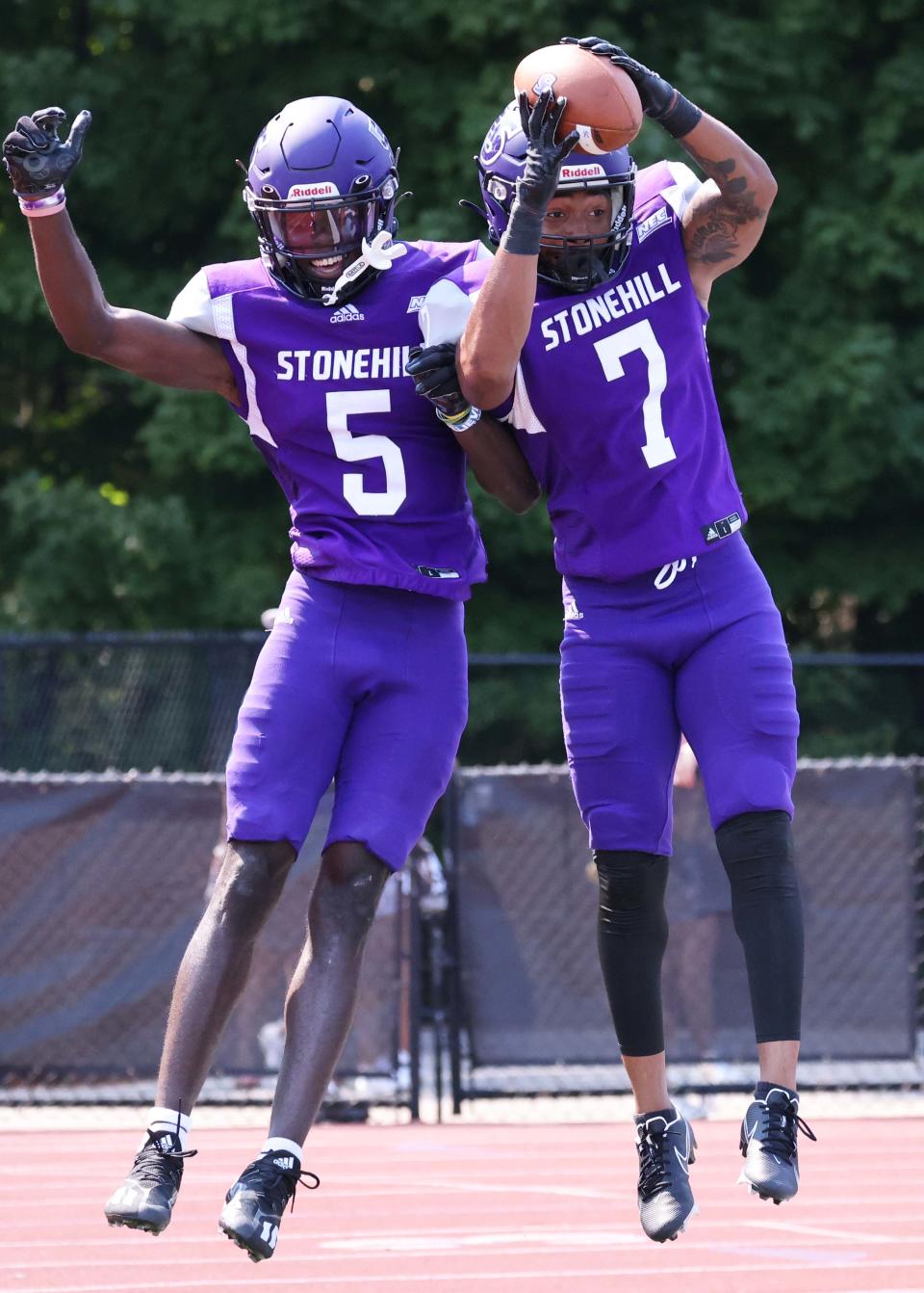 Stonehill's Chris Domercant, left, makes the touchdown catch and is congratulated by DeAaron Lawrence during a game versus Post University on Saturday, Sept. 10, 2022. 