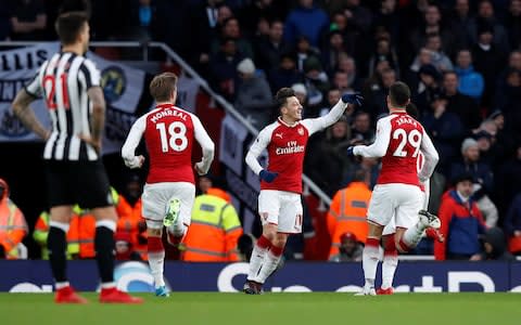 Mesut Ozil celebrates scoring for Arsenal - Credit: REUTERS