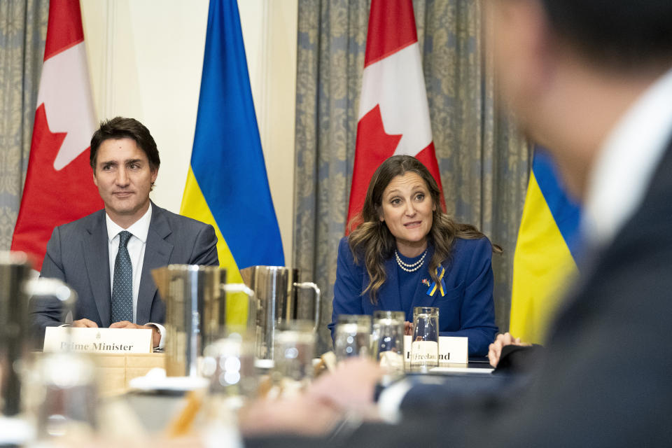 Deputy Prime Minister and Minister of Finance Chrystia Freeland, right, speaks ahead of a meeting with business leaders alongside Prime Minister Justin Trudeau, left, and Ukrainian President Volodymyr Zelenskyy, in Toronto, on Friday, Sept. 22, 2023. (Spencer Colby/The Canadian Press via AP)