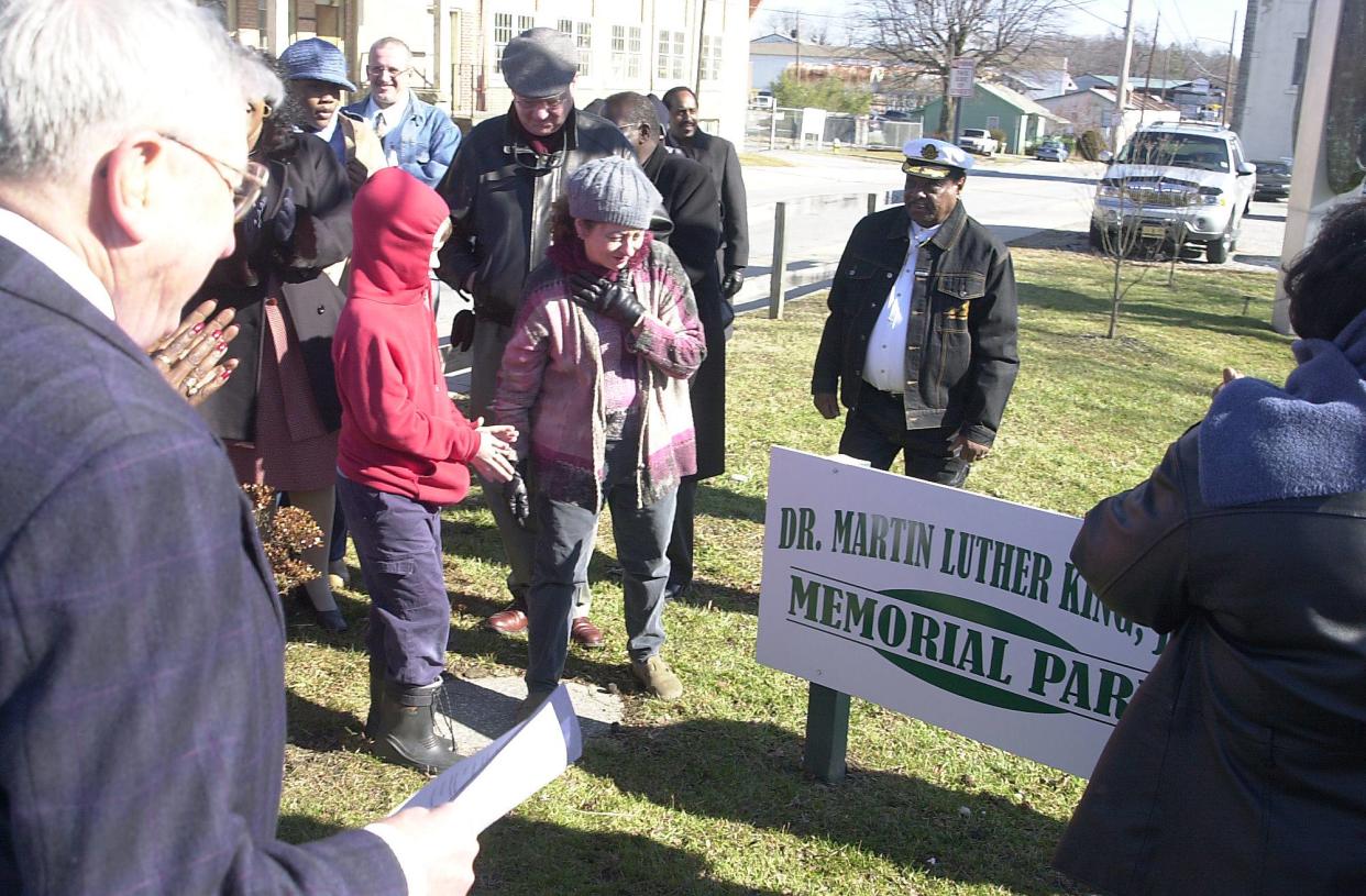 People look at the Dr. Martin Luther King, Jr. Memorial Park sign after its unveiling during a dedication ceremony back in 2004.