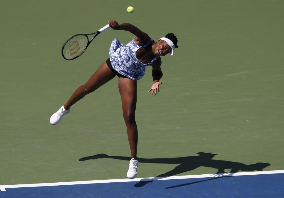 Venus Williams of the U.S. serves to Kimiko Date-Krumm of Japan during their match at the 2014 U.S. Open tennis tournament in New York, August 25, 2014. REUTERS/Mike Segar (UNITED STATES - Tags: SPORT TENNIS)