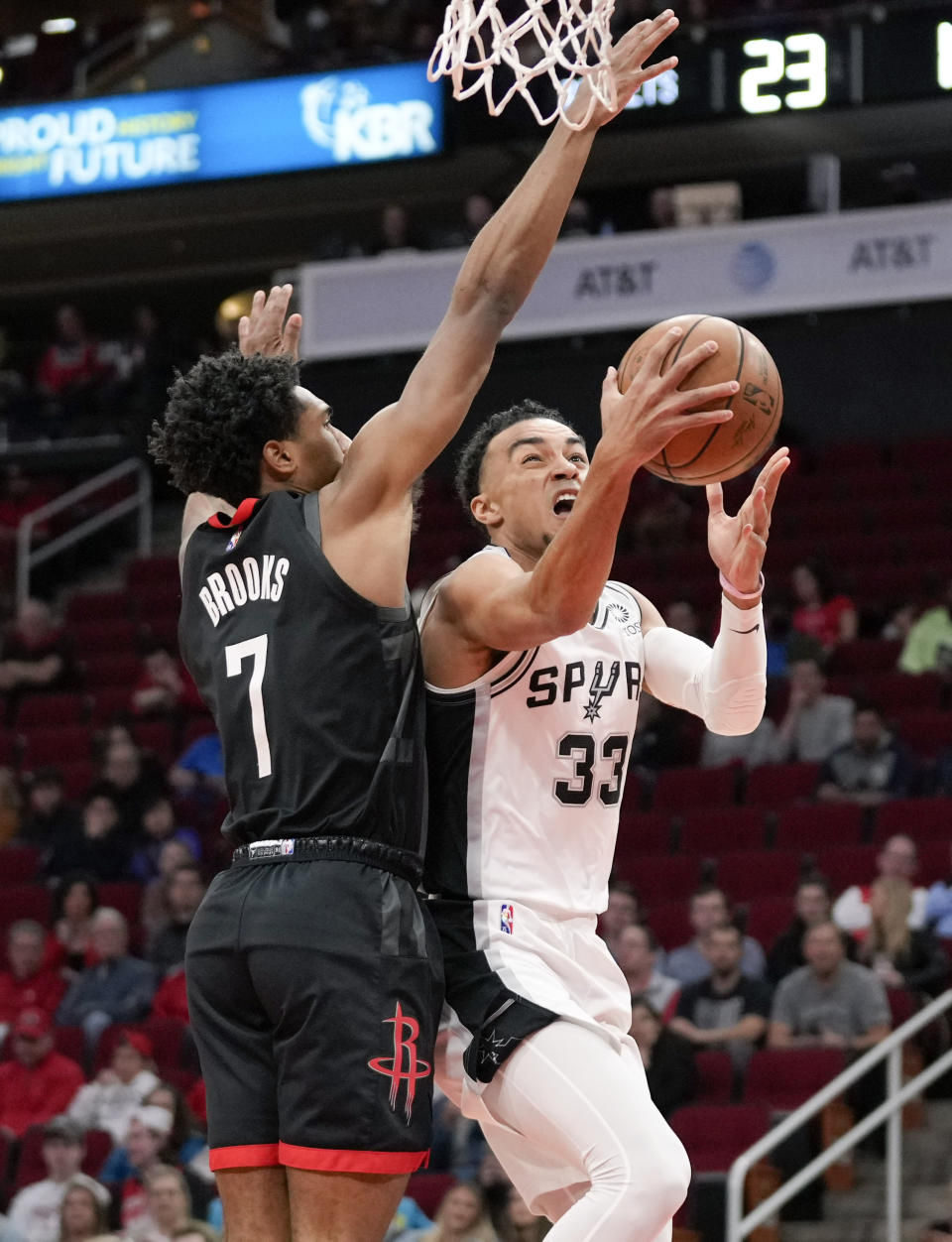 San Antonio Spurs guard Tre Jones (33) drives to the basket as Houston Rockets guard Armoni Brooks defends during the first half of an NBA basketball game, Tuesday, Jan. 25, 2022, in Houston. (AP Photo/Eric Christian Smith)