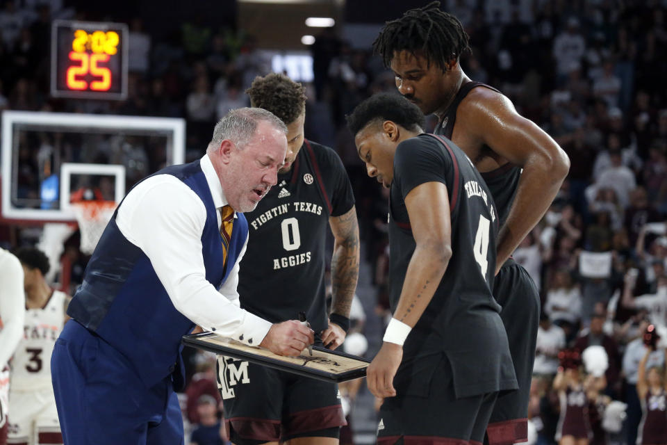 Feb 25, 2023; Starkville, Mississippi; Texas A&M Aggies head coach Buzz Williams (left) huddles his team during a timeout during the second half against the Mississippi State Bulldogs at Humphrey Coliseum. Petre Thomas-USA TODAY Sports