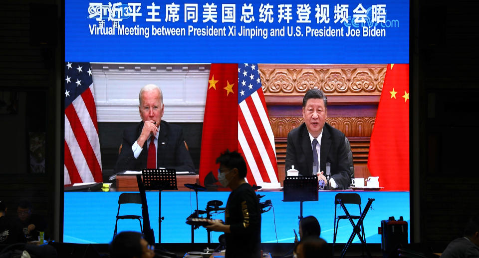 A screen shows Chinese President Xi Jinping attending a virtual meeting with U.S. President Joe Biden via video link, at a restaurant in Beijing, China November 16, 2021. Source: Reuters