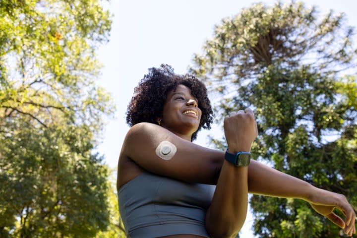 Woman exercises with her Apple Watch and Dexcom G7.