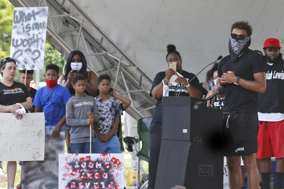 Atlanta Hawks guard Trae Young, right, speaks during a peaceful rally Monday, June 1, 2020, in his hometown of Norman, Okla., calling attention to the killing of George Floyd by Minneapolis police on May 25. (AP Photo/Sue Ogrocki)S