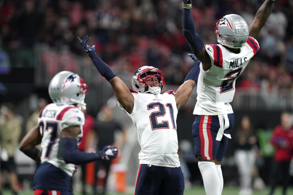 New England Patriots safety Adrian Phillips (21) and New England Patriots cornerback Jalen Mills (2) celebrate stopping the Atlanta Falcons during the second half of an NFL football game, Thursday, Nov. 18, 2021, in Atlanta. (AP Photo/Brynn Anderson)