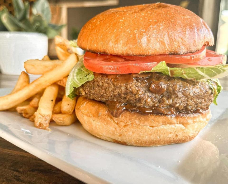 The Downtown Burger ($18) is a brown rice and miso-shiitake patty, onion jam, lettuce and tomato, served with fries (or Caesar salad).