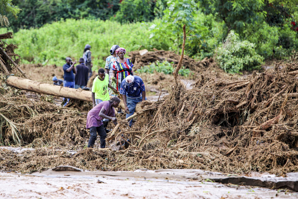 People try to clear the area after a dam burst, in Kamuchiri Village Mai Mahiu, Nakuru County, Kenya, Monday, April 29, 2024. Kenya's Interior Ministry says at least 45 people have died and dozens are missing after a dam collapsed following heavy rains. (AP Photo/Patrick Ngugi)