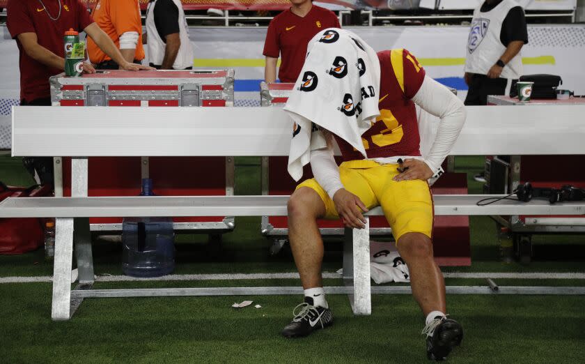 LAS VEGAS, NV - DECEMBER 2, 2022: USC Trojans quarterback Caleb Williams (13) sits under a towel on the bench.