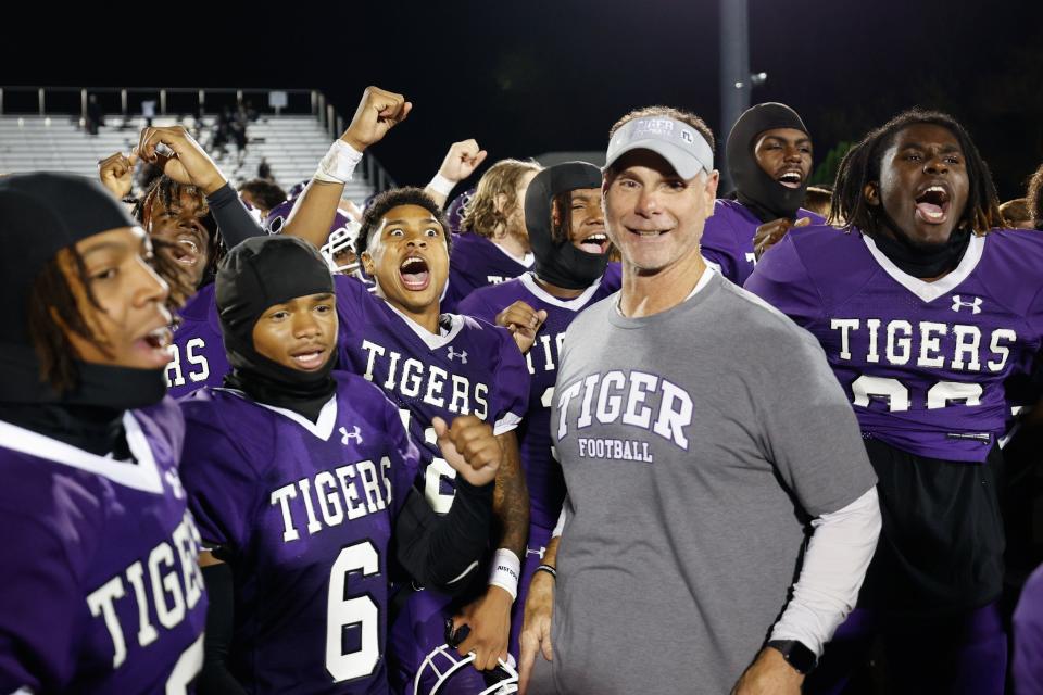 14. Pickerington Central coach Jeff Lomonico and his players celebrate a first-round playoff win over New Albany on Oct. 27.