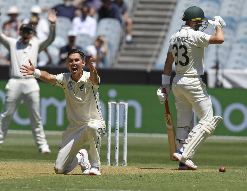 New Zealand's Trent Boult, left appeals for an LBW against Australia's Marnus Labuschagne, right, during play in the cricket test match in Melbourne, Australia, Thursday, Dec. 26, 2019. (AP Photo/Andy Brownbill)