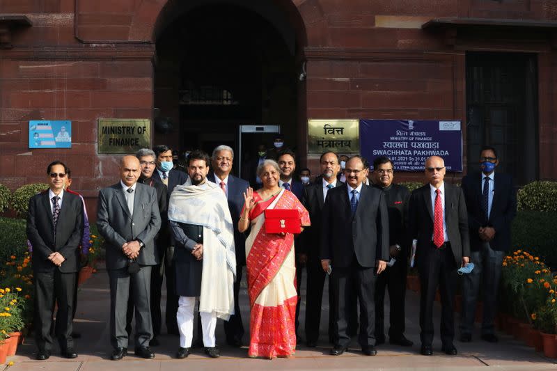 India's Finance Minister Nirmala Sitharaman stands next to Minister of State for Finance and Corporate Affairs Anurag Thakur as she leaves her office to present the federal budget in the parliament in New Delhi